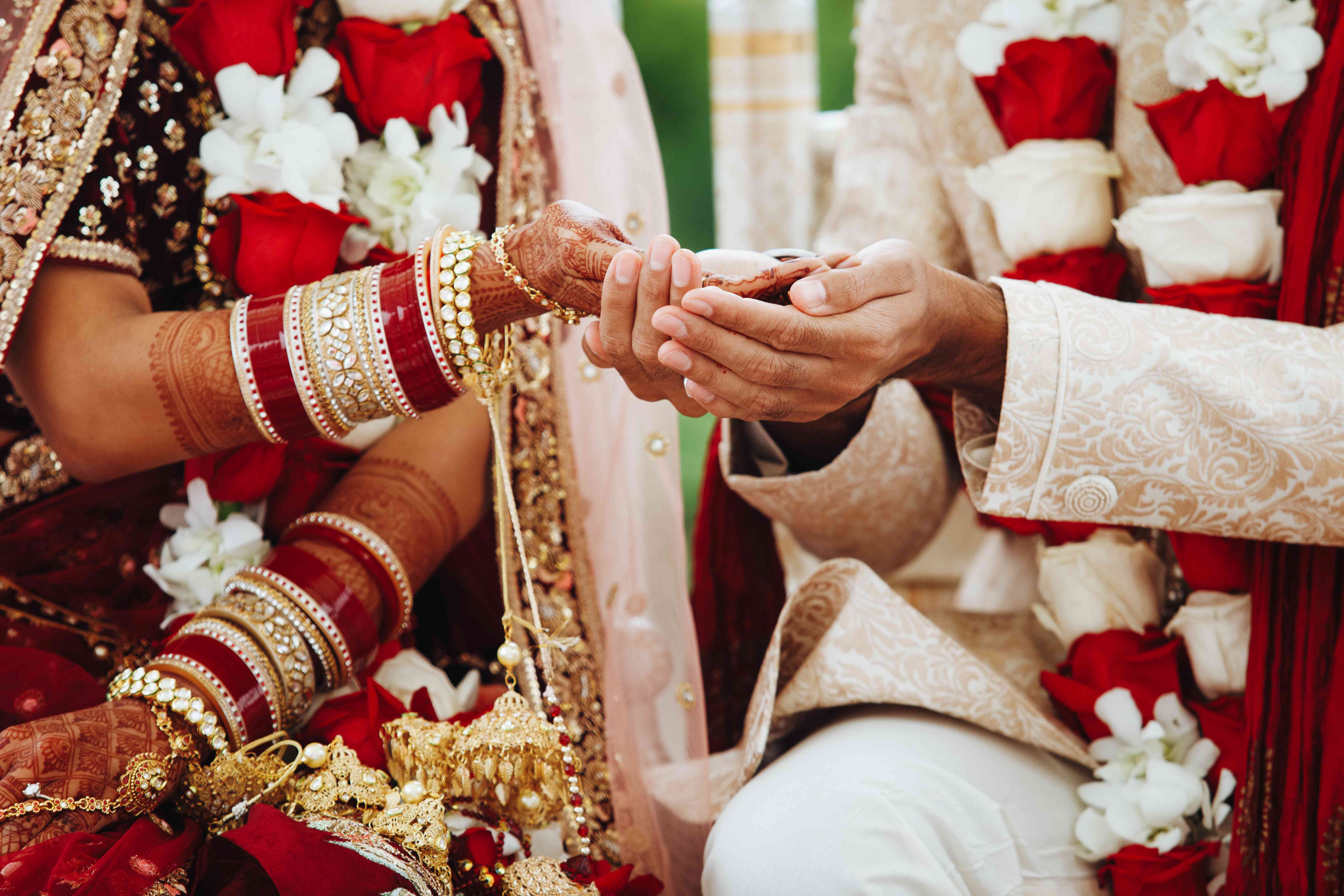 Indian wedding ceremony - bride and groom hands intertwined